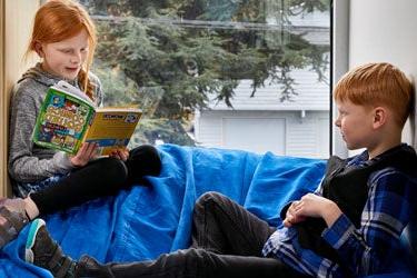 Two students read together.